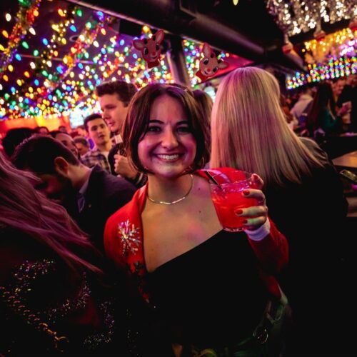 Girl at Holiday party with drink in hand