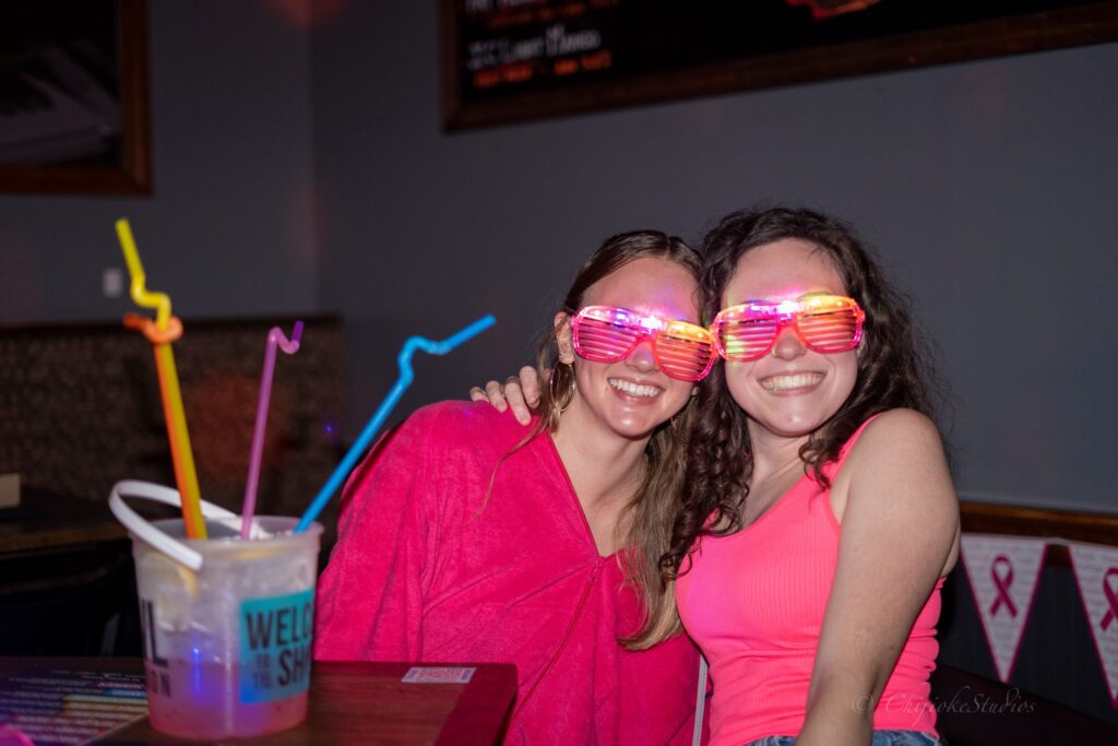 Pittsburgh table reservation with two girls wearing pink light up glasses